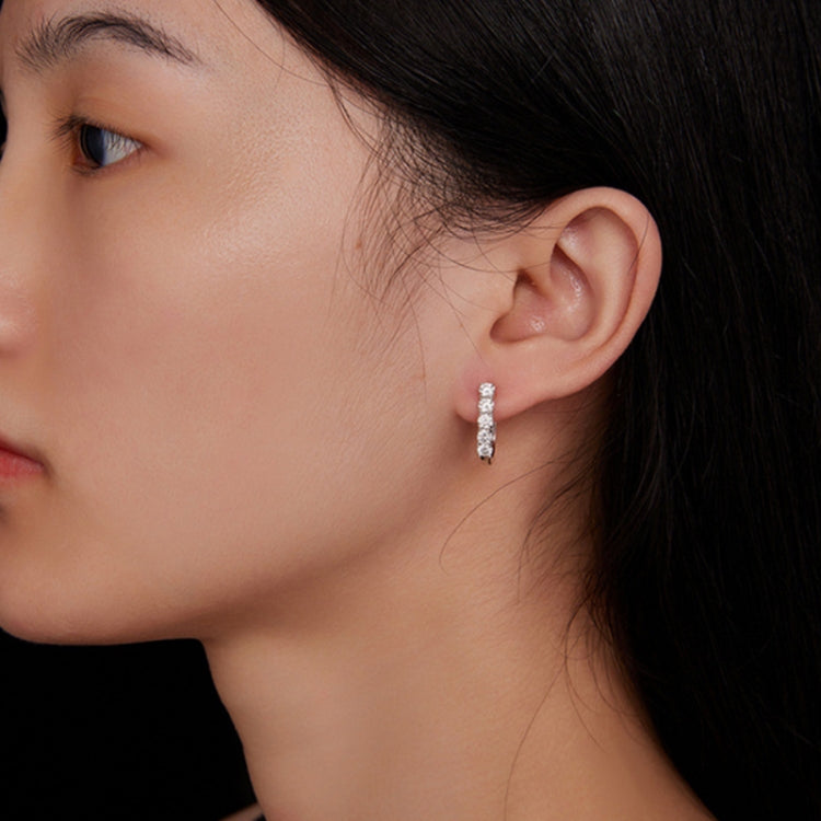 U-shaped hoop earrings with stacked stones shown on a close-up ear