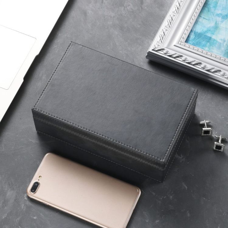 Dark gray stitched phone shielding box with hinged top flap and a phone inside