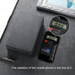 Dark gray phone shielding box with radiation tester displays beside it