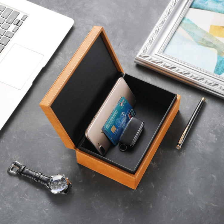 Orange phone shielding box open with phone and small items inside