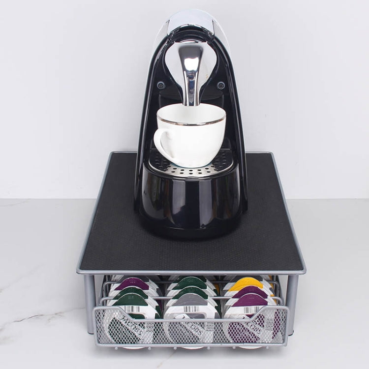 Coffee capsule holder drawer with black top and front wire tray holding multicolor pods