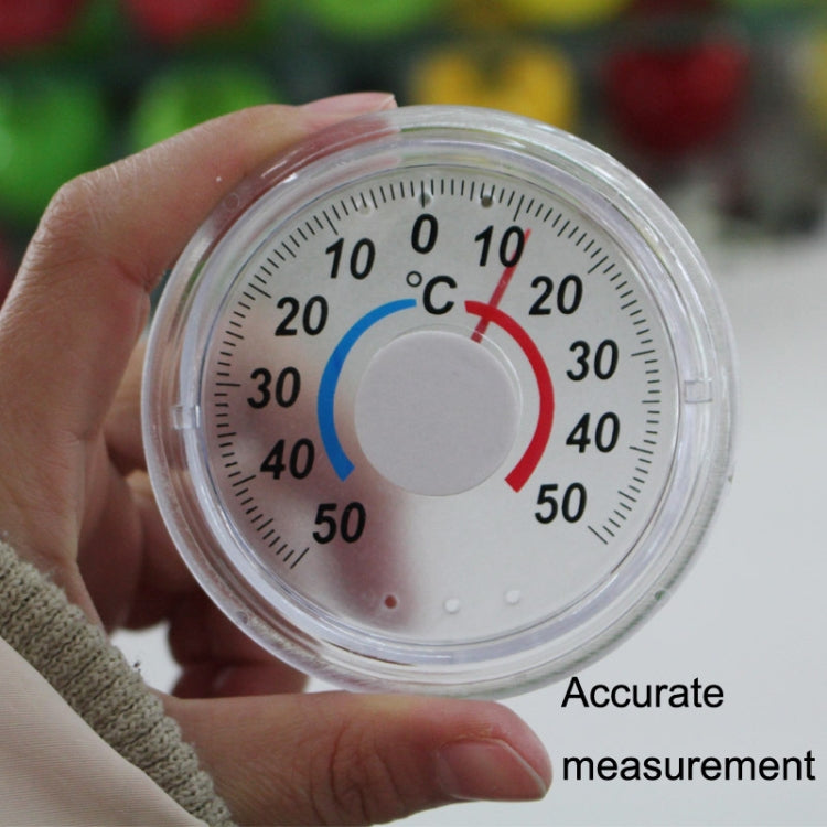 Round plastic thermometer with °C dial and blue/red indicator ring