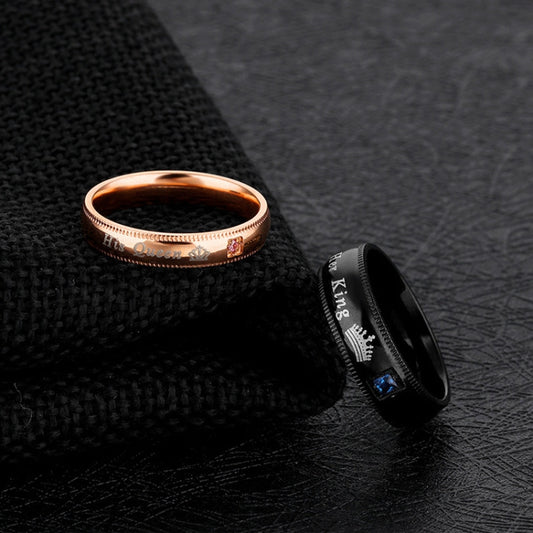 Rose-gold and black couple rings with engraved lettering and blue gemstone inlay