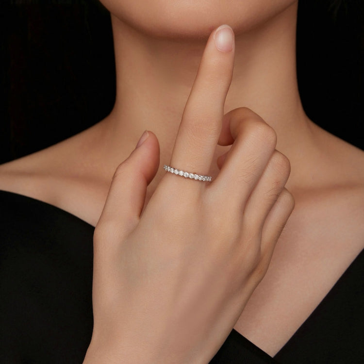 Silver small-stone ring with bright round stones worn on finger