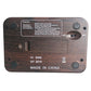 Wood-grain digital chess clock back panel with buttons and compliance labels