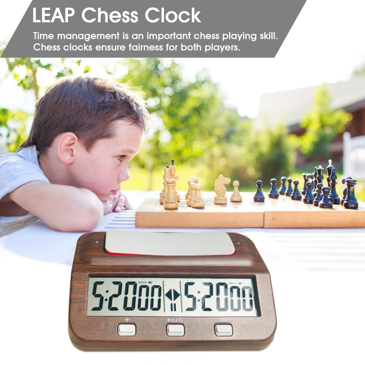 Wood-grain digital chess clock on tabletop with red bar and twin time readouts