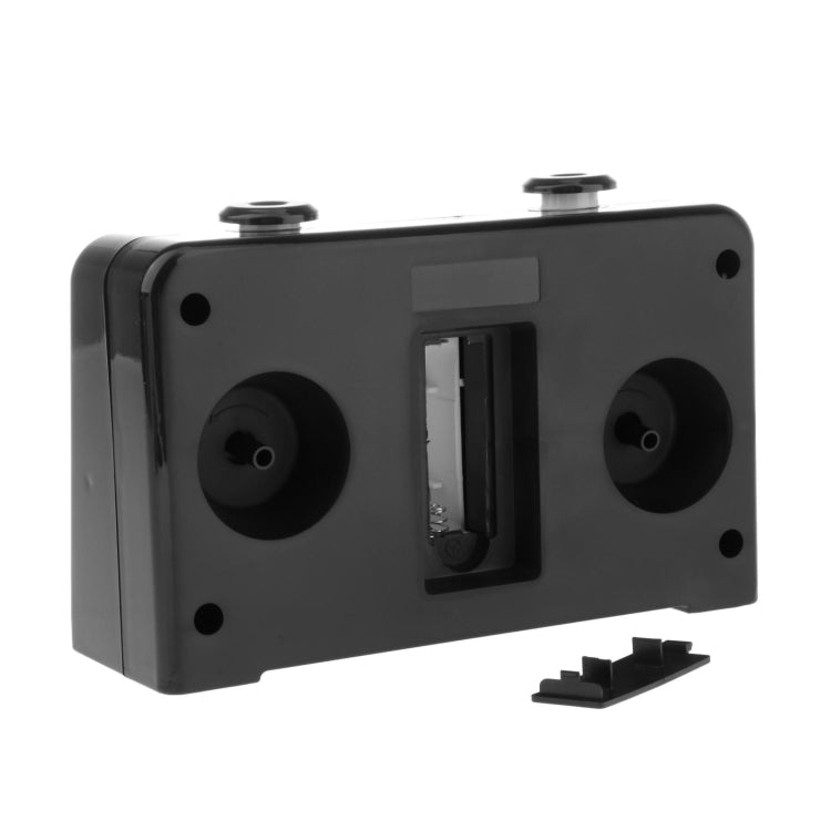 Black chess timer back panel with battery compartments and a central port slot