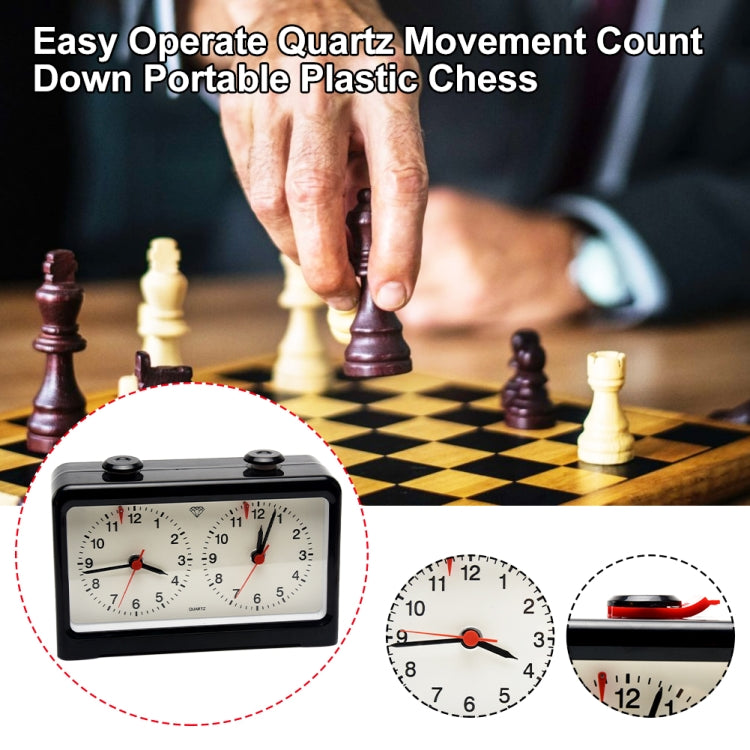 Portable chess timer with quartz dials and red hands during a chess match