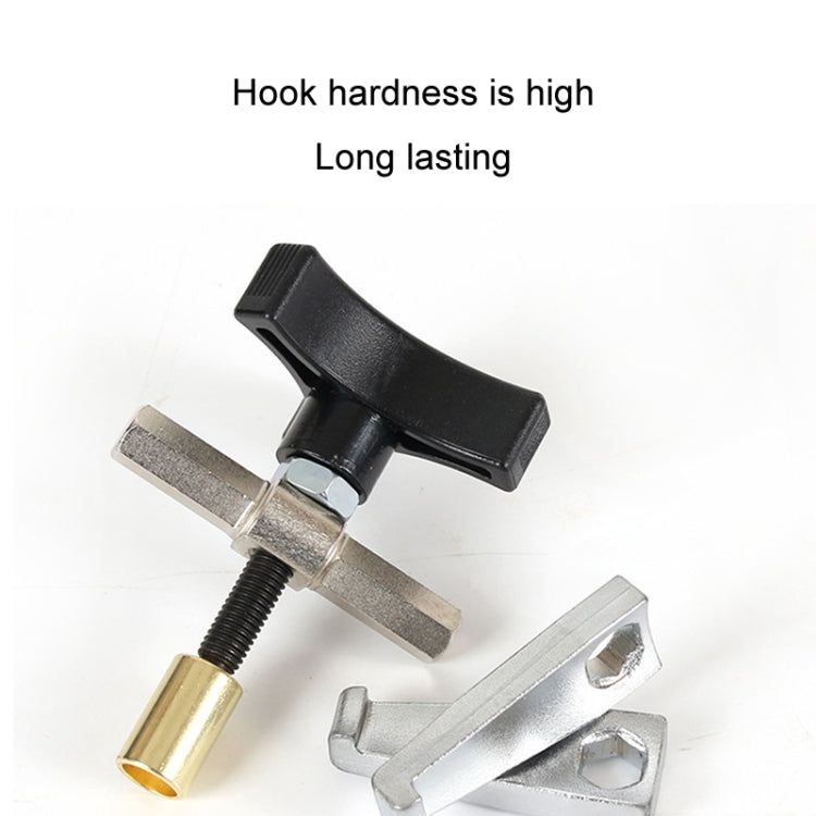 Automotive glass removal tool with black lever handle, silver claws, brass cylinder end