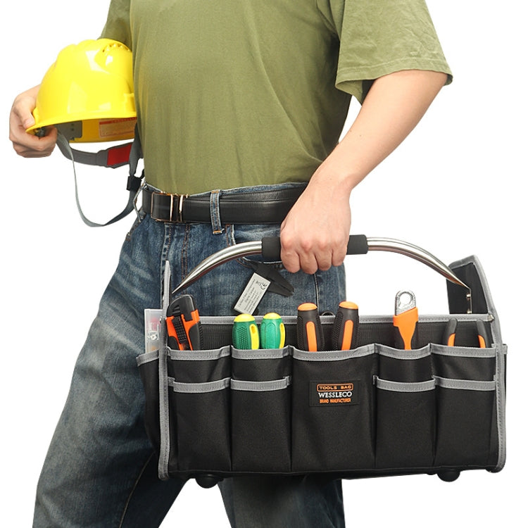 Black tool tote carried by hand with gray pocket lining and hanging organizer segments