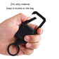 Black clip-on keychain with secure strap loop and rounded housing, held by hand