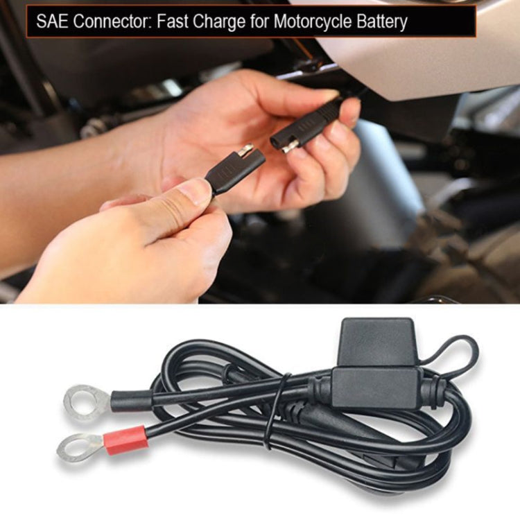 SAE battery quick-connect cable with black housing and ring terminals held by hands
