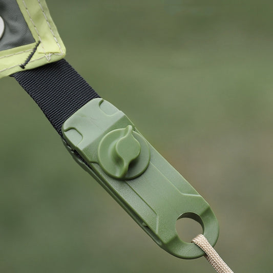 Dark green shark clip securing tent fabric edge and cord