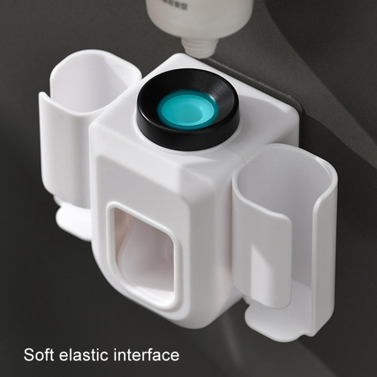 Close-up of white automatic toothpaste squeezer with black squeeze top and tube cradle