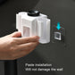 White wall-mounted toothpaste squeezer with removable installation pad and secure mounting