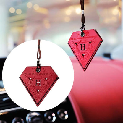 Red triangular leather rearview mirror charm with black H medallion, on brown cord