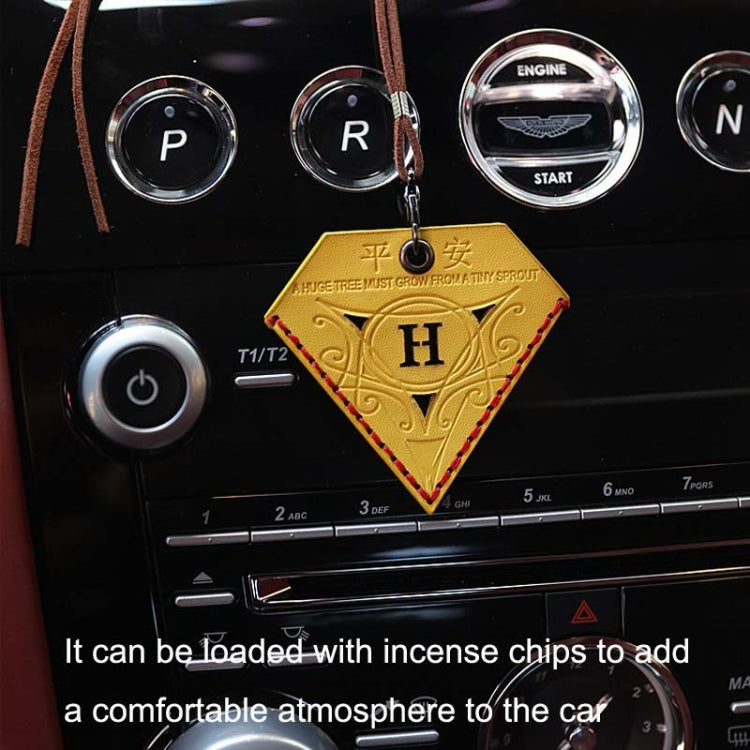 Yellow triangular leather rearview mirror charm with H emblem, hanging from brown cord