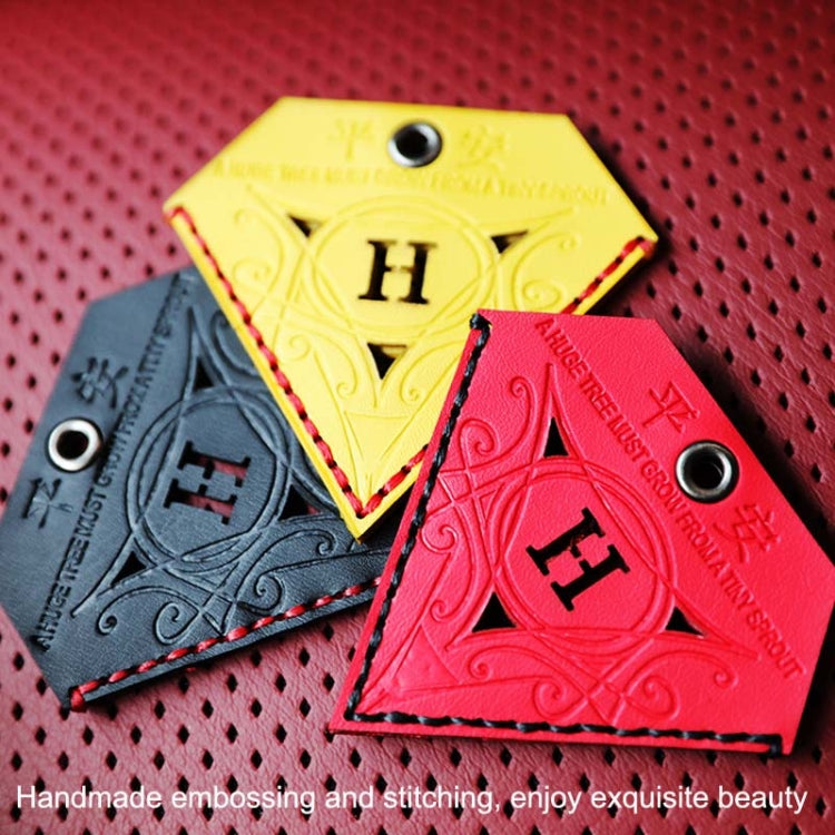 Triangular leather charm set in red, yellow, and gray/black with embossed H symbols