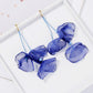 Blue fabric petal drop earrings with thin blue strings and gold-tone hooks