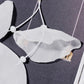 White sheer fabric petal earrings with hanging tassel cords and gold-tone hooks