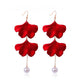 Red fabric petal drop earrings with white pearl dangle and gold-tone hooks