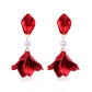 Red satin petal drop earrings with white pearl dangle and gold-tone hooks