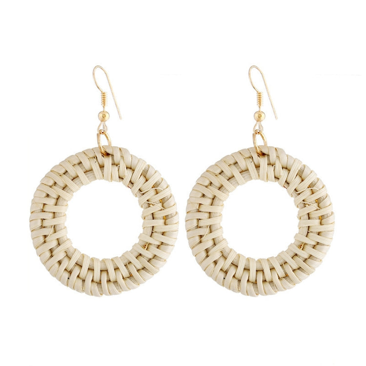 Handmade woven circular hoop earrings with gold-tone ear hooks, natural beige fiber.