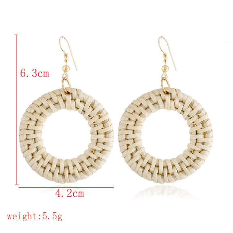 Handmade woven circular hoop earrings with gold-tone ear hooks, natural beige fiber.
