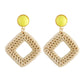 Handmade woven diamond hoop earrings with yellow stud tops and gold-tone hooks, beige.