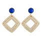 Handmade woven diamond hoop earrings with blue stud tops and gold-tone hooks, beige.