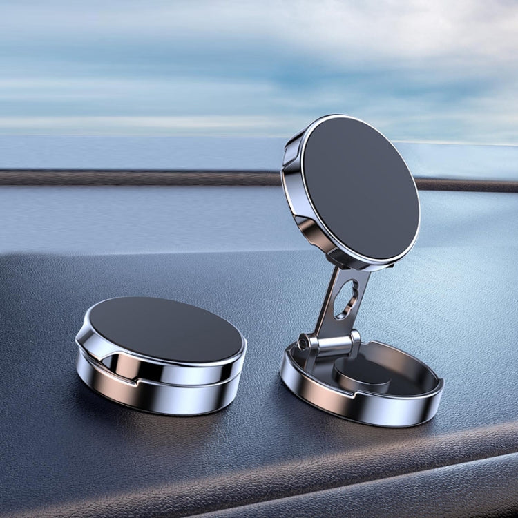 Silver circular car magnetic suction phone bracket with open base on dashboard