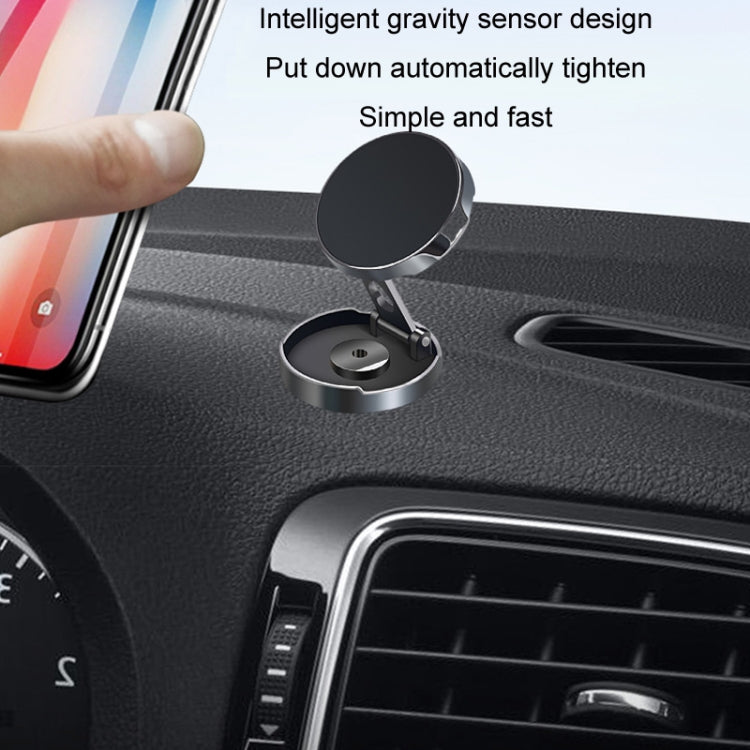 Car magnetic suction phone bracket mounted on dashboard next to a phone