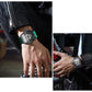 Green silicone sports quartz watch worn on wrist, black skeleton dial with metal accents