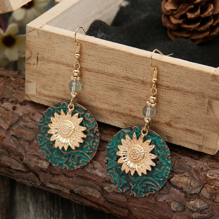Sunflower drop earrings with teal patterned round discs, gold accents, and crystal beads