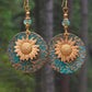 Sunflower drop earrings with teal circular backing, gold flower centers, and dangle beads