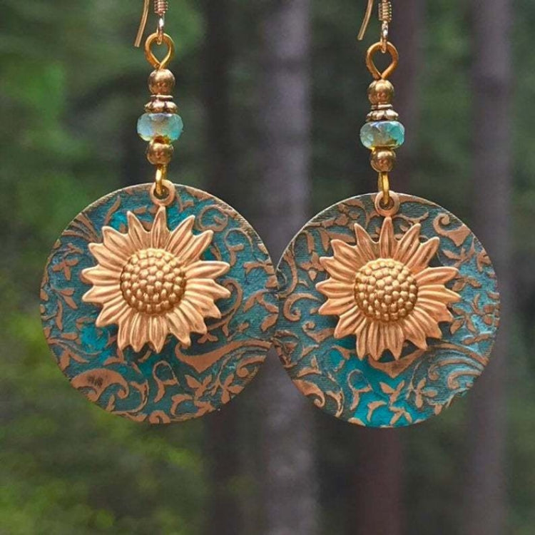 Sunflower drop earrings with teal circular backing, gold flower centers, and dangle beads
