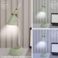 Green diamond desk lamp lighting at different brightness settings on a desk