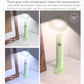 Green folding desk lamp with glowing top, warm and cool light appearance
