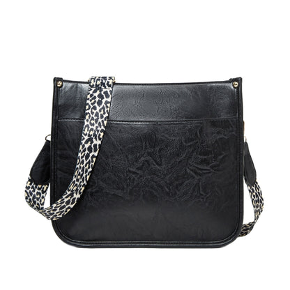 Black PU leather crossbody tote bag with leopard-print strap and front flap pocket