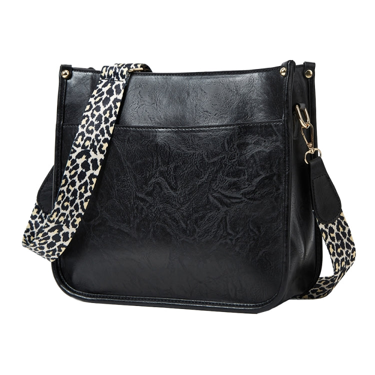 Black PU leather crossbody tote bag with leopard-print strap and side accessory pocket
