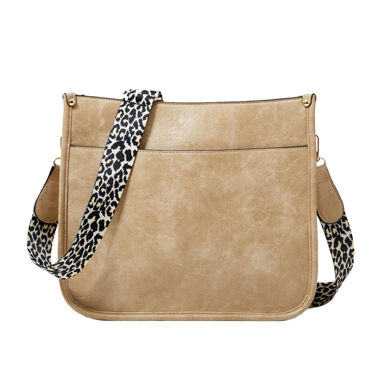 Tan PU leather crossbody tote bag with leopard-print strap and front panel seams