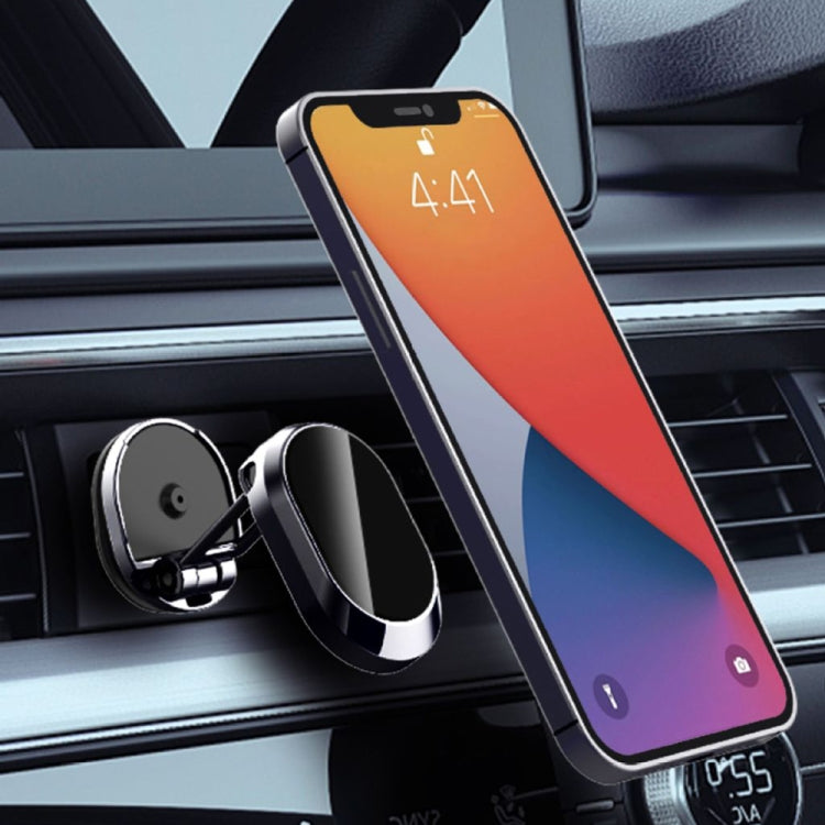 Silver and black magnetic car phone mount holding a smartphone on the air vent