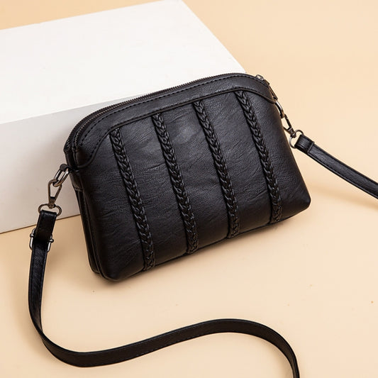 Black double-layer crossbody handbag with top zipper and braided vertical stripe panels