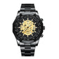 Black metal wristwatch with gold skeleton skull dial and tachymeter bezel