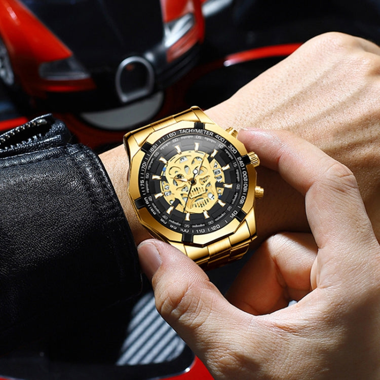 Gold-tone quartz skull watch with black dial skeleton on wrist, metal bracelet