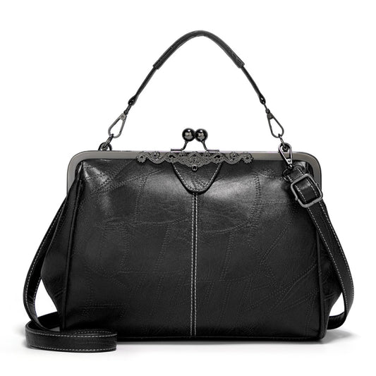 Black vintage-style leather crossbody bag with buckle clasp and adjustable strap.