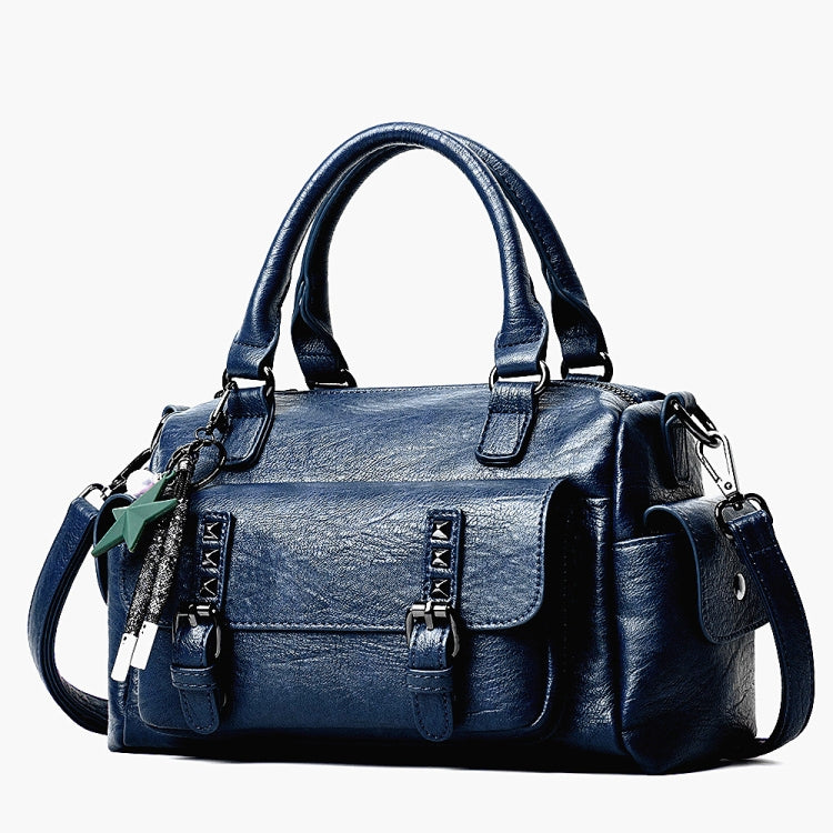 Navy blue pebbled leather handbag with top handles, crossbody strap, and front flap pocket