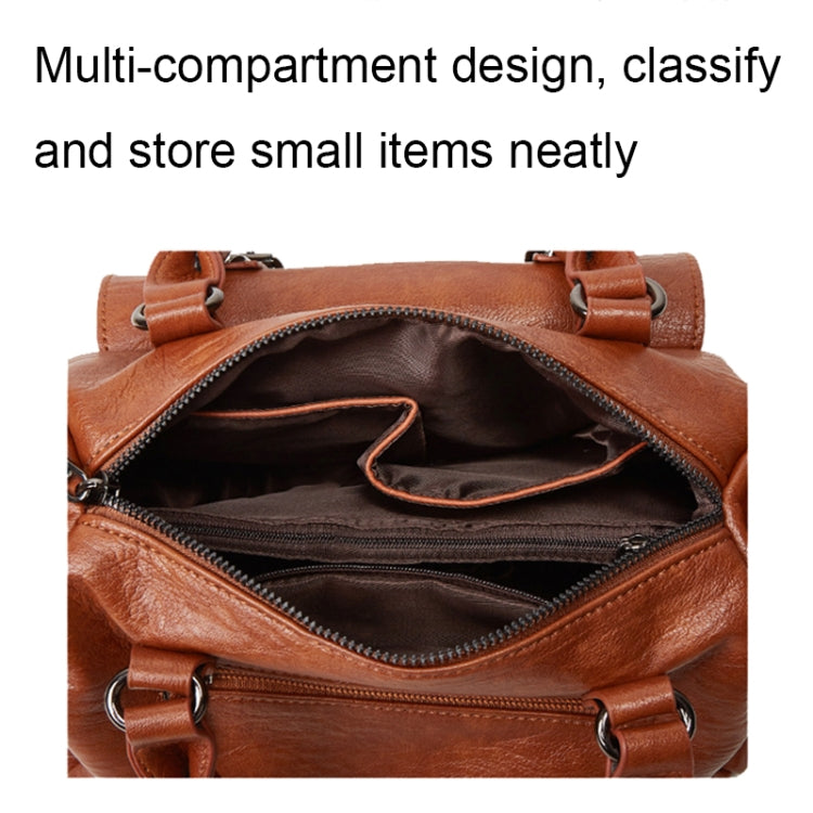 Brown pebbled leather handbag open to show interior compartments and zipper pocket