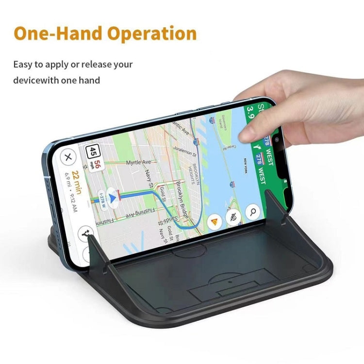Black silicone dashboard phone bracket with phone pressed in by hand