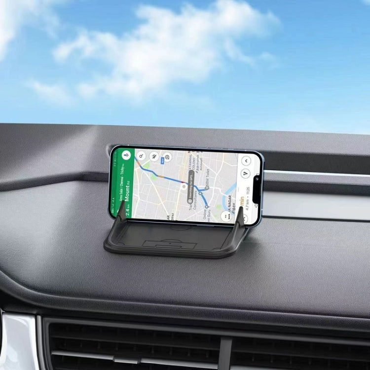 Black silicone phone navigation bracket mounted on car dashboard